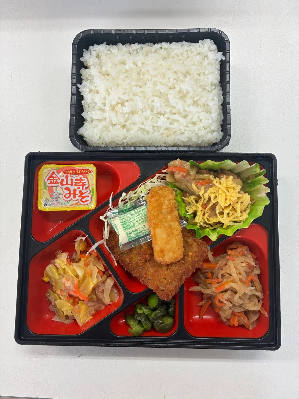 揚げ物(とんかつと思われる)とハッシュポテトがメインの弁当