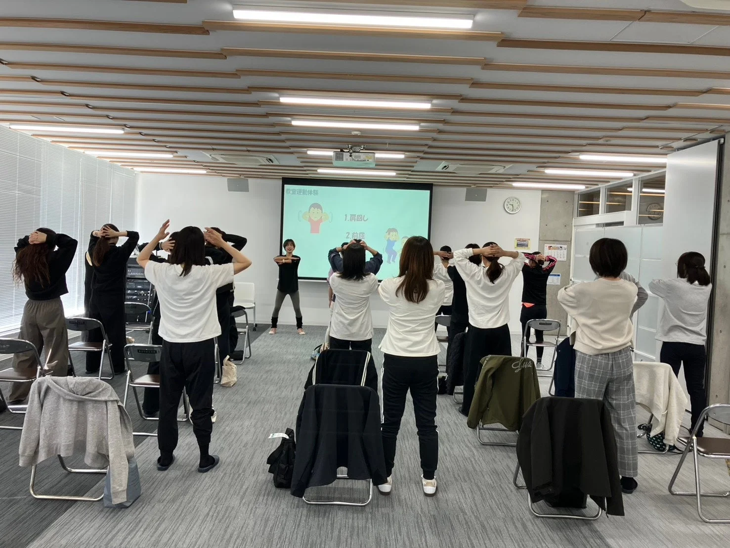 オフィスで健康運動をする人々