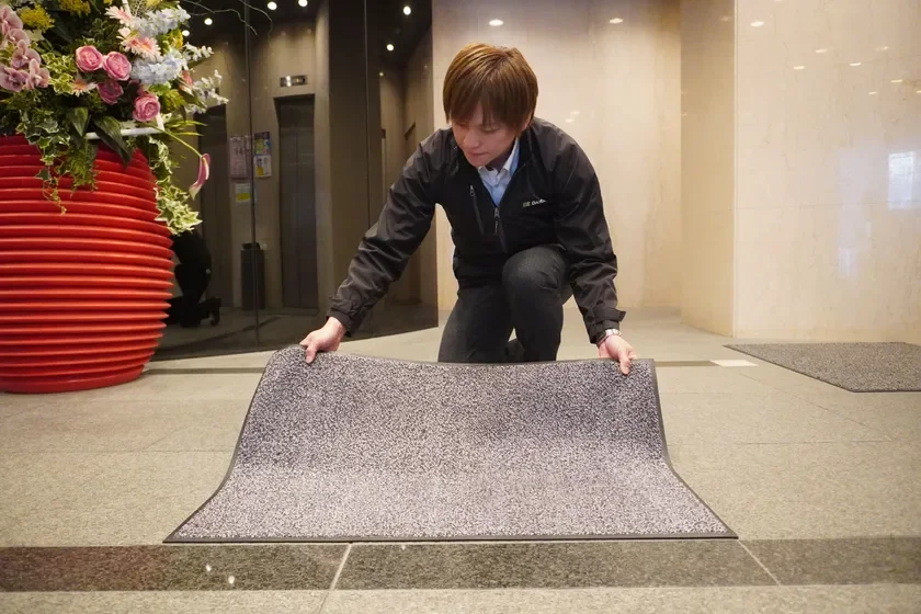 男性がマットを設置している画像