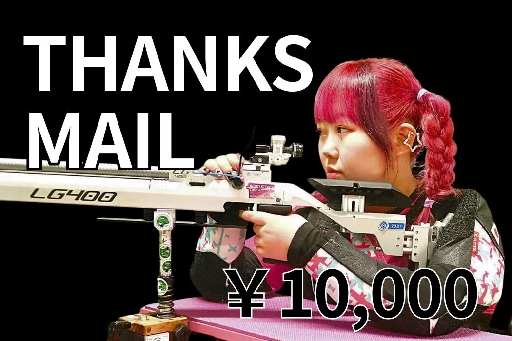 ピンク色の髪の女性射撃選手がライフルを構えている画像で、「THANKS MAIL」や「¥ 10,000」の文字が見られる。